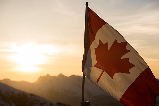 Canadian Flag at sunset Canadian flag in the mountains at sunset canadian culture photos stock pictures, royalty-free photos & images