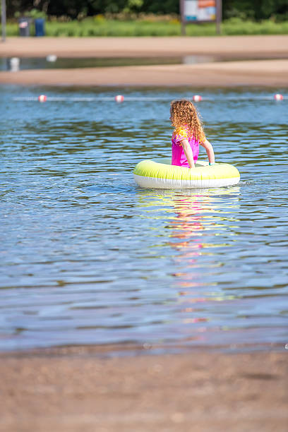 istock Girl Playing In Inner Tube Float Toy At Beach 546201298
