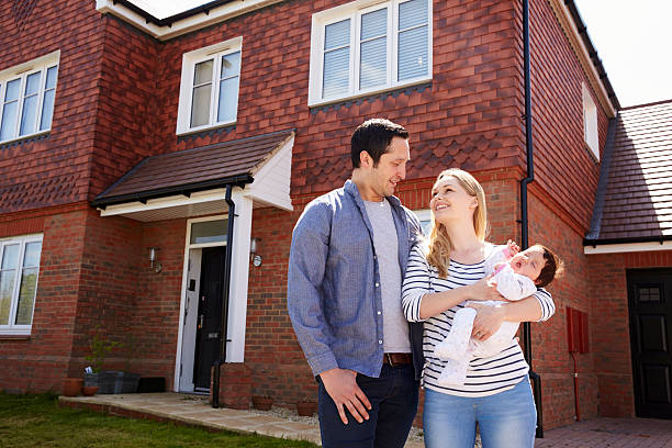 istock Young Family Standing Outside New Home 546201796