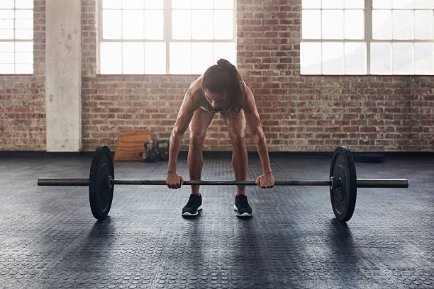 istock Fit young woman working out with a barbell 546202054
