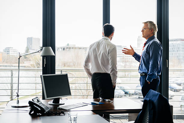 istock Mature Businessmen standing close to a window and talking 546202826