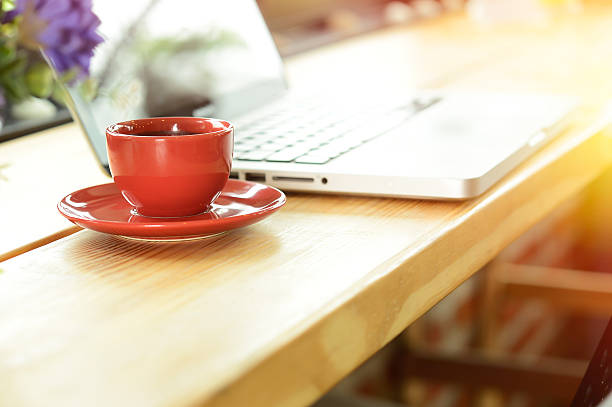 istock coffee cup and laptop on desk in cafe 546204038