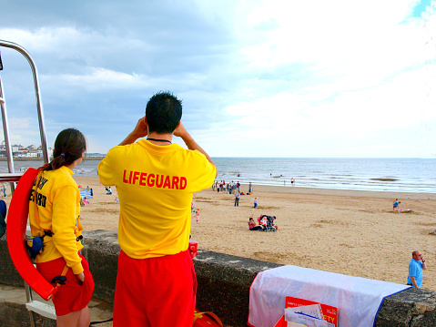 Bridlington, North Yorkshire, UK. August 13, 2008.   Two lifeguards on duty scanning the south beach at Bridlington in North Yorkshire