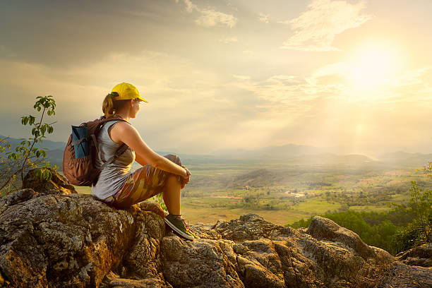istock woman backpacker sitting on top of the mountain 546205630