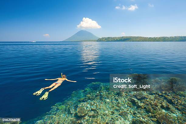 Woman Snorkeling In Clear Tropical Waters On Background Of Island Stock Photo - Download Image Now