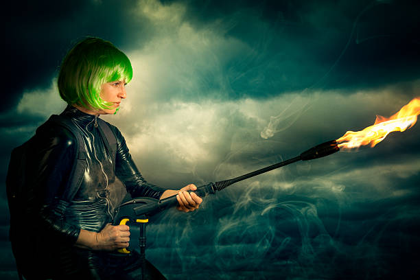 manga styled female superhero with flame thrower - flamethrower imagens e fotografias de stock