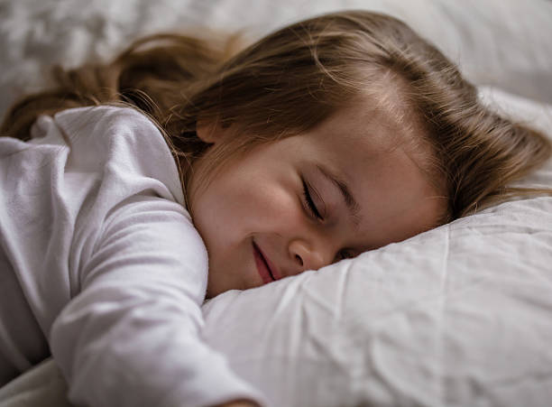 istock little girl falls asleep in bed on white pillow 546208076