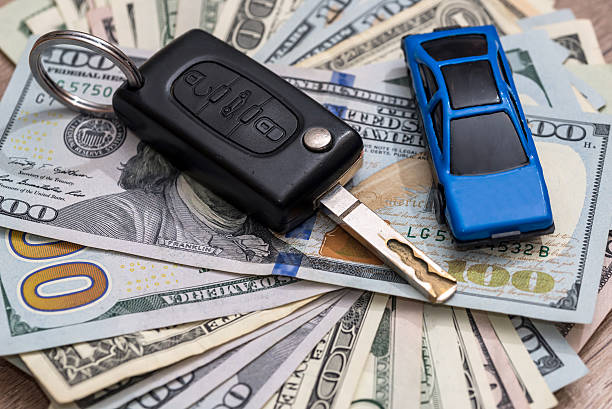 istock car key with pen and dollar 546208226
