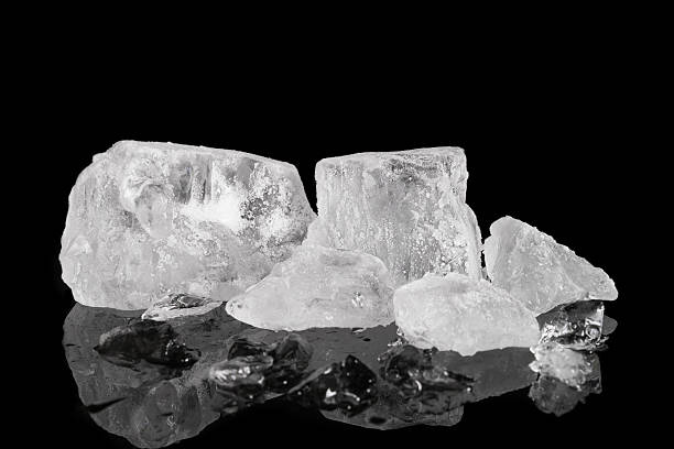 istock Pile of different ice cubes on reflection table on black background 546209460