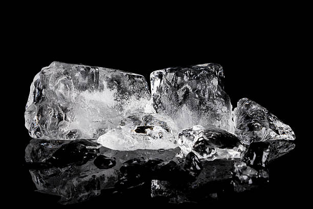 istock Pile of different ice cubes on reflection table on black background 546210212