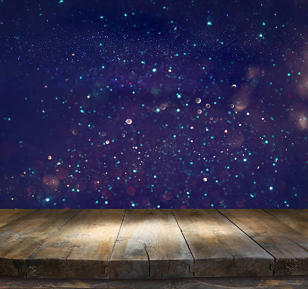 istock wooden table in front of glitter lights background 546210494