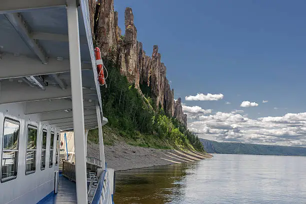 A travel boat arrived to National heritage of Russia Lena Pillars placed in republic Sakha, Siberia. View from a boat