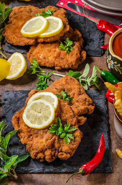 istock Schnitzel with fries, salad and herbs 546422872