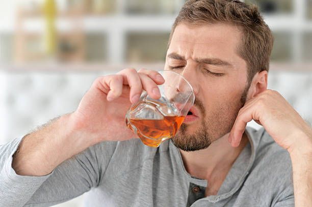 istock man with whiskey in glass 546423016