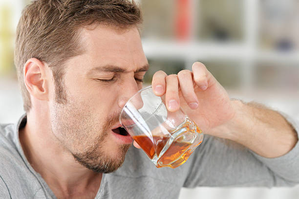 istock man with whiskey in glass 546423524