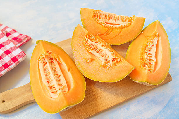 istock Cantaloupe melon slices on rustic wooden table 546424454