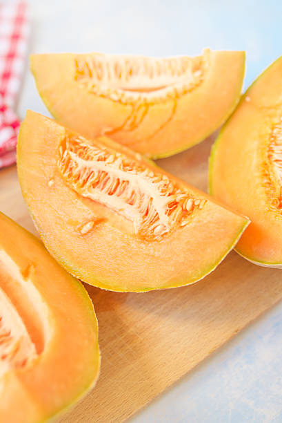 istock Cantaloupe melon slices on rustic wooden table 546424490