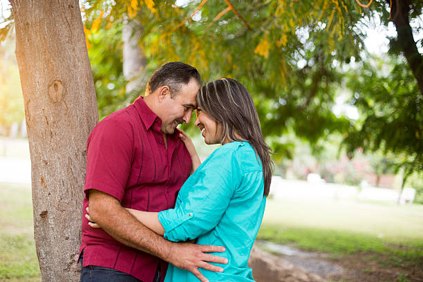 istock Latin couple embracing face to face and smiling 546425236