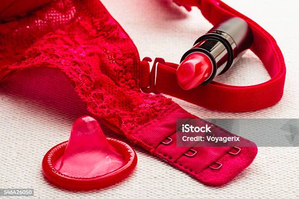 black lace underwear near condom, handcuffs and condom on bed Stock Photo  by LightFieldStudios