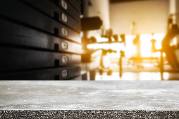 Fitness gym and empty wooden desk space. stock photo