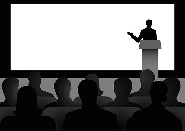 Man Giving A Speech On Stage Silhouette illustration of man figure giving a speech on stage with blank big screen as the background presentation speech stock illustrations