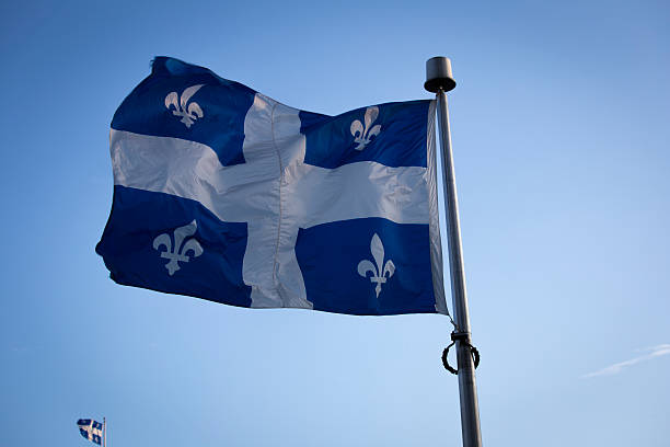 istock Big Quebec Flag Flying with a Small one 546431578