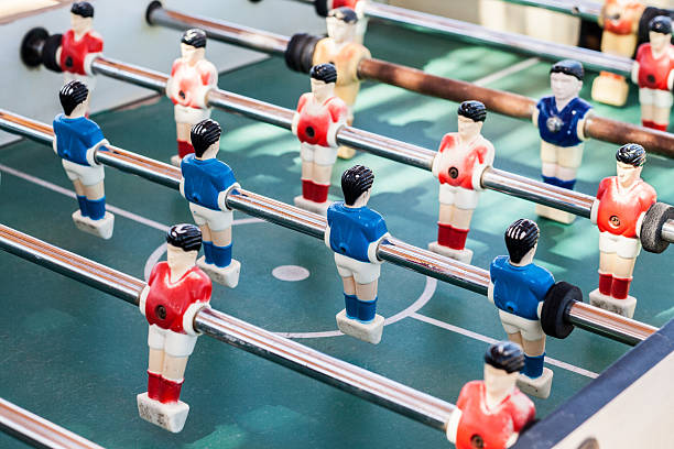 istock colored table football game with young players 546432404