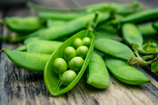 istock Green peas on a wooden table 546433720