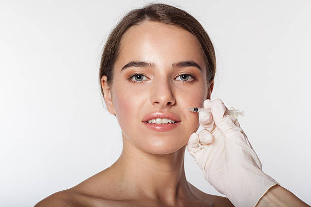 Girl getting beauty injection for face stock photo