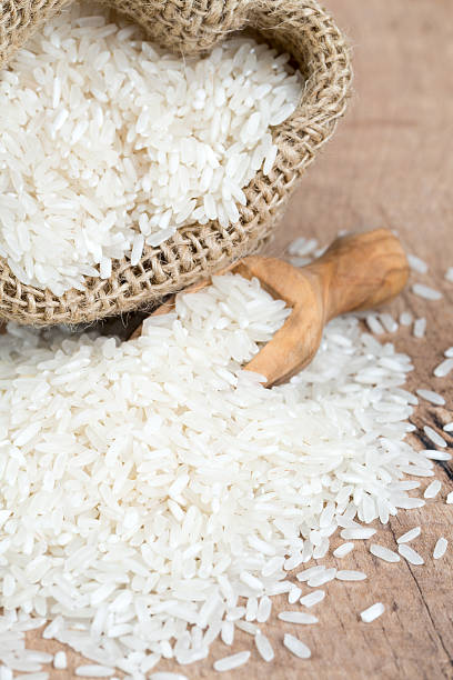 istock rice in a burlap bag on wooden surface 546435330