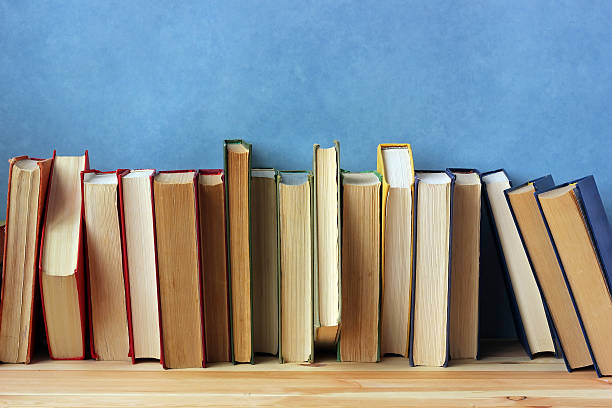 istock Books on a shelf against a blue wall. 546435844