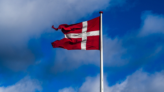 Naval version of the danish flag dannebrog is a darker red