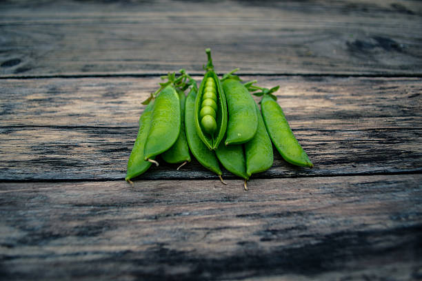 Green peas on a wooden table