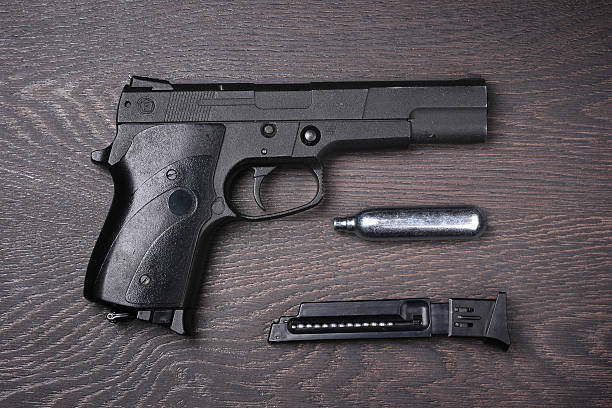 istock Black pneumatic pistol against a dark background. 546436700