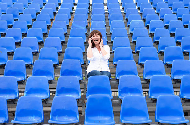 istock Lone middle-aged woman in a stadium 546436794