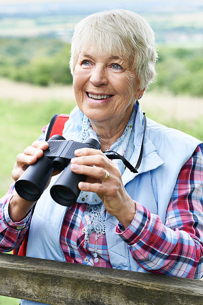 istock Senior Woman On Walk With Binoculars 546437608