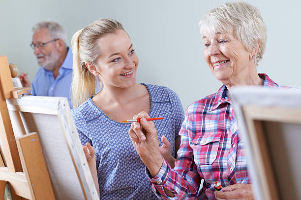 istock Seniors Attending Painting Class With Teacher 546437948