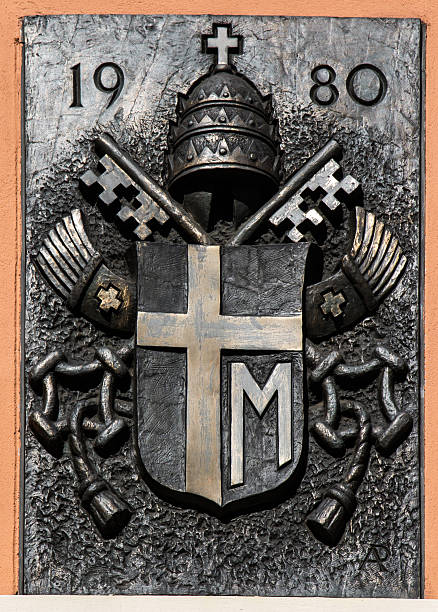 Mount St. Anna, Poland - July 7, 2016: Arms Pope St. John Paul II on the wall of the Basilica of St. Anne of Mount St. Anna, Poland.