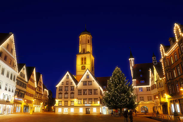 Biberach, Germany - December 20, 2015: Town square in the old town of Biberach illuminatedat dusk, decorated for christmas, Christmas Tree and Martinskirche church are visible in the background. Biberach an der Riss, Upper Swabia, Baden Wurttemberg, Germany.