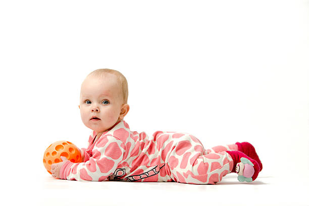 Little girl playing with a ball stock photo