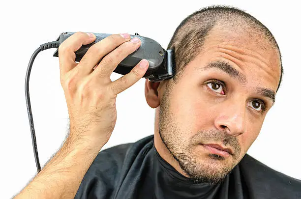 Photo of Man holds the trimming machine and beautify yourself