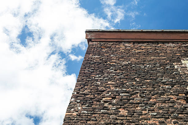 istock Old brick wall from an ancient house with blue sky 546442362