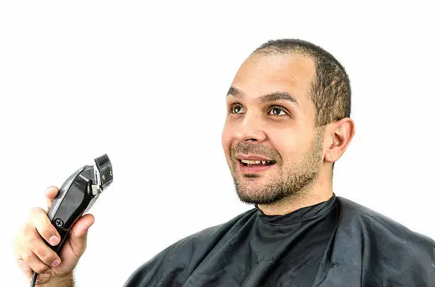 Photo of Man holds the trimming machine and beautify yourself