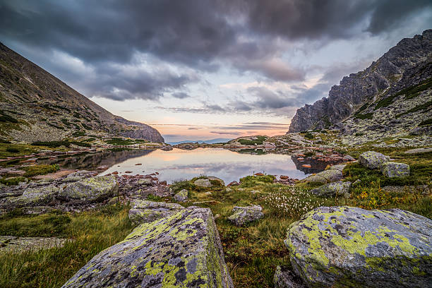 istock Mountain Lake with Rocks in Foreground at Sunset 546443166