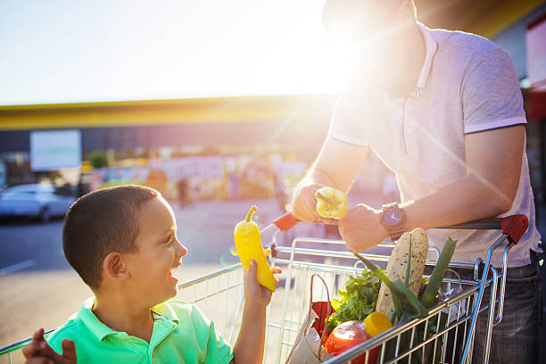 istock Father and son having fun after grocery shopping 546443554