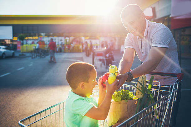 istock Father and son having fun after grocery shopping 546444014