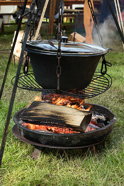 istock Big cooking pot placed on fire in a camping outdoors 546444140
