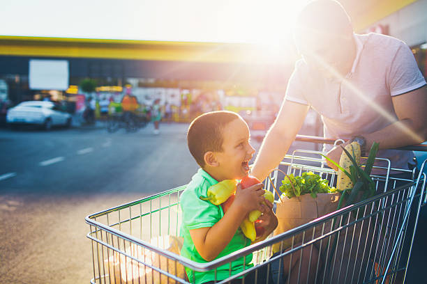 istock Father and son having fun after grocery shopping 546444406