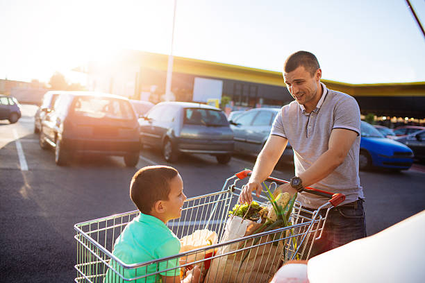 istock Father and son packing groceries 546445920