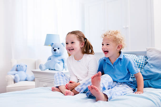 istock Kids playing in white bedroom 546446290